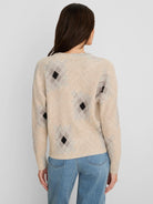 Beige shaker stitch sweater with black and faded grey diamond print.