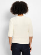 Off-white, fuzzy sweater with 3/4 sleeves, subtle puff shoulders, and a crew neck, shown from the back.