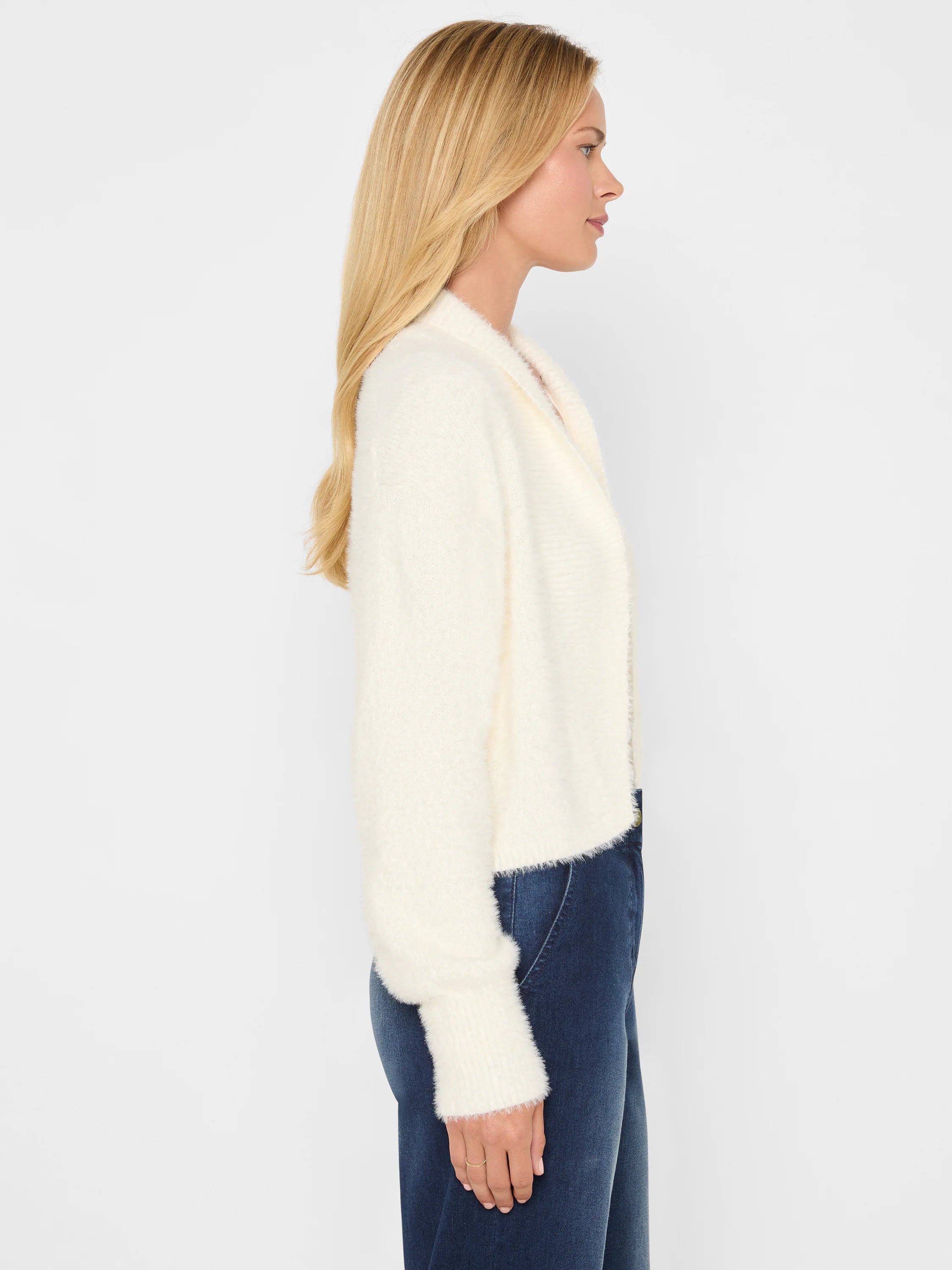 Cream fuzzy open cardigan with a shawl collar and ribbed cuffs.