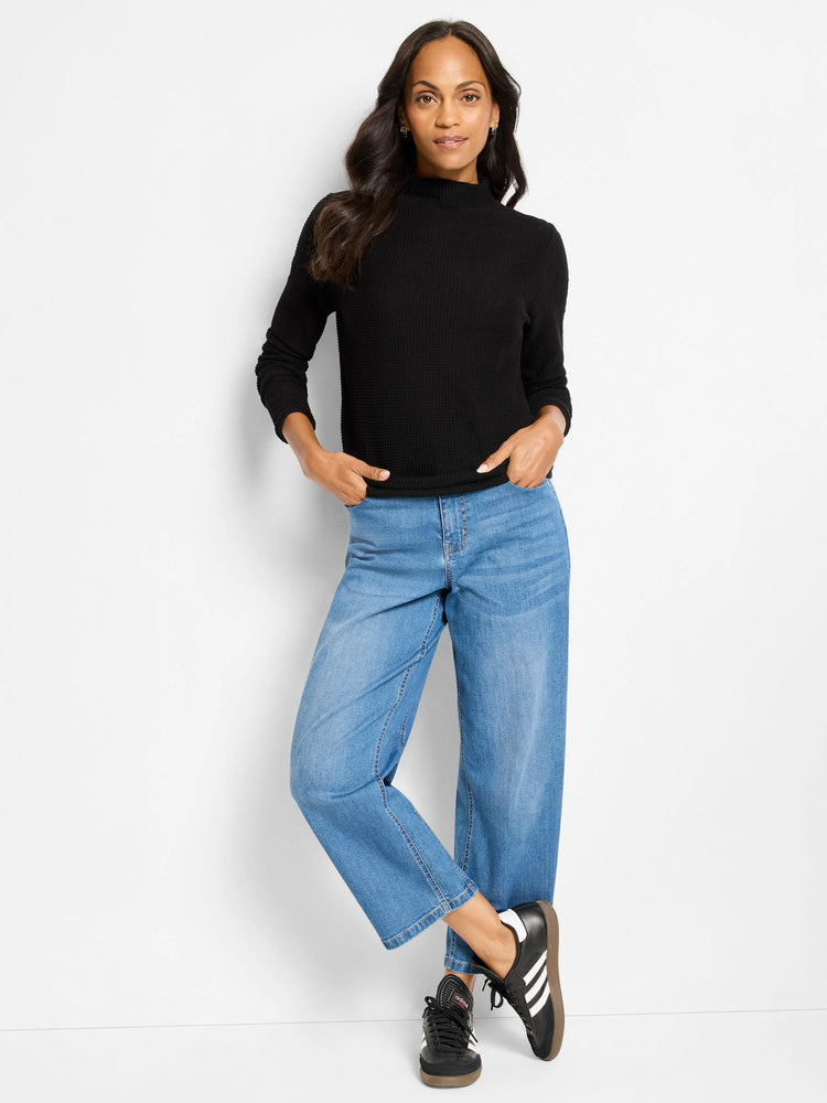 Black long-sleeve mock neck sweater with a visible pixel knit texture.