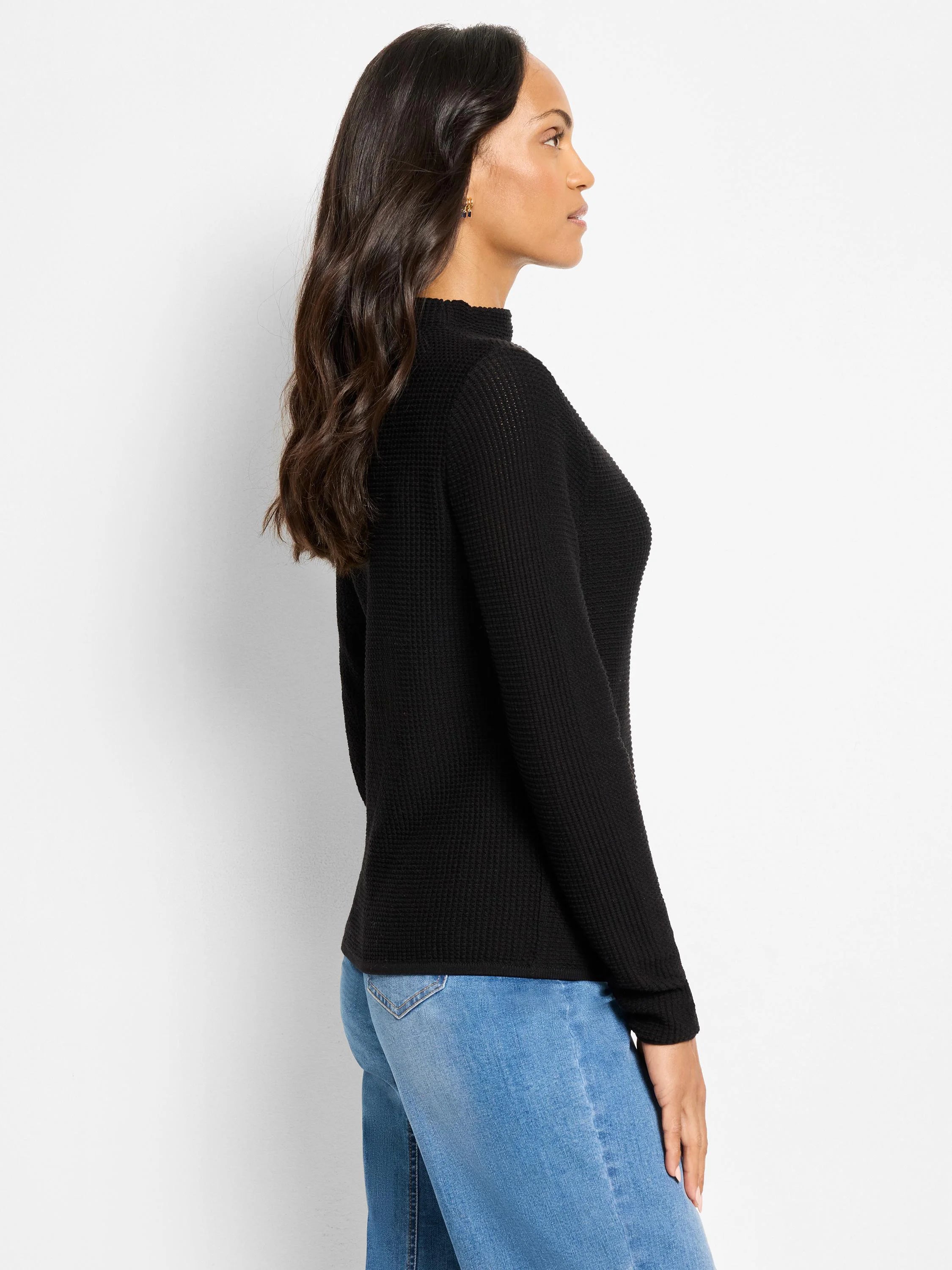 Black pixel knit sweater with a high neck and long sleeves.