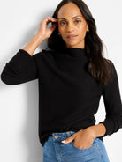 Black knit sweater with a textured waffle pattern and mock neck.