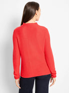 Red pixel knit sweater with a mock neck and long sleeves, featuring a distinct textured knit.