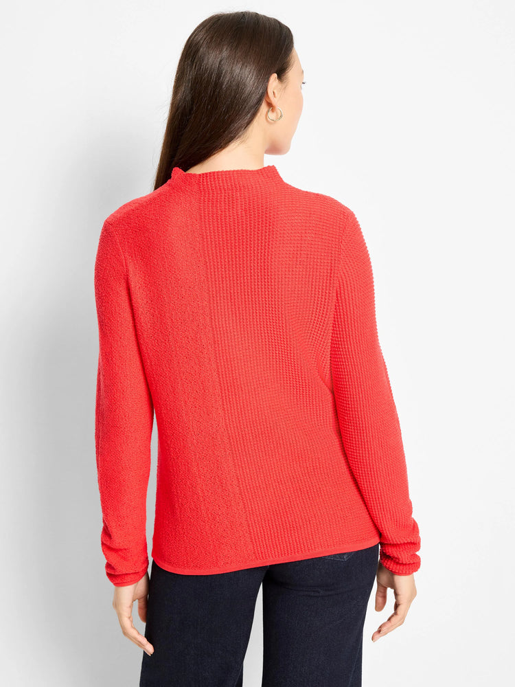 Red pixel knit sweater with a mock neck and long sleeves, featuring a distinct textured knit.