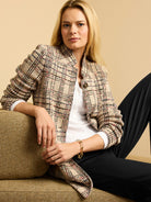 Beige knit plaid blazer with black and red lines, band collar, and gathered sleeves.