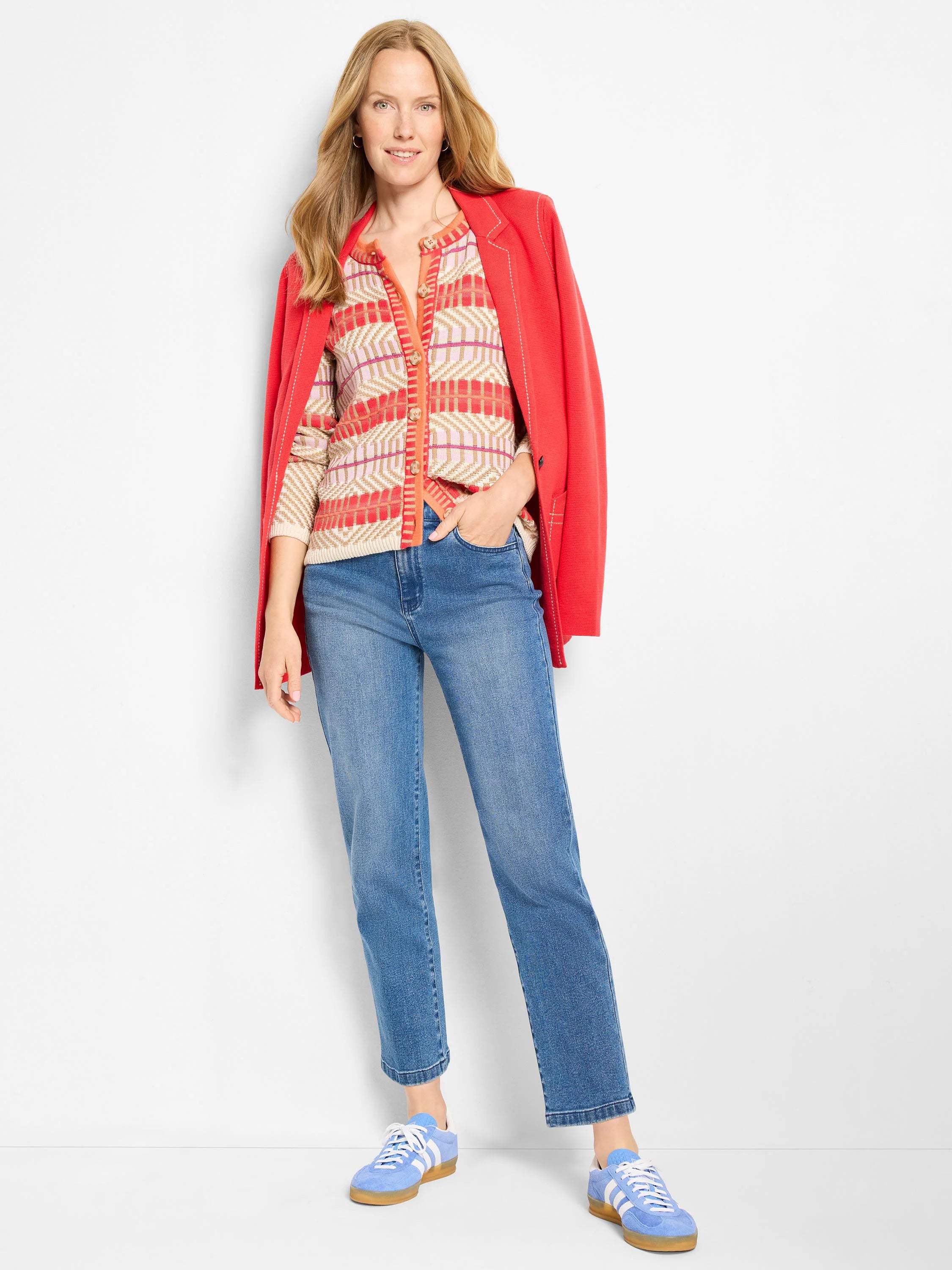 Cream, red, and pink geometric knit cardigan with light brown buttons and long sleeves.