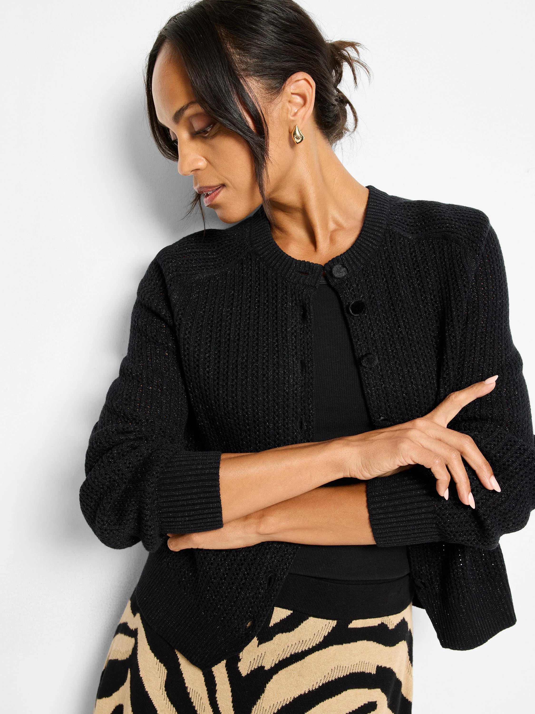 Black sparkly knit cardigan with a round neck and front buttons.