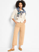 Off-white open-knit button-front cardigan with a perforated texture.