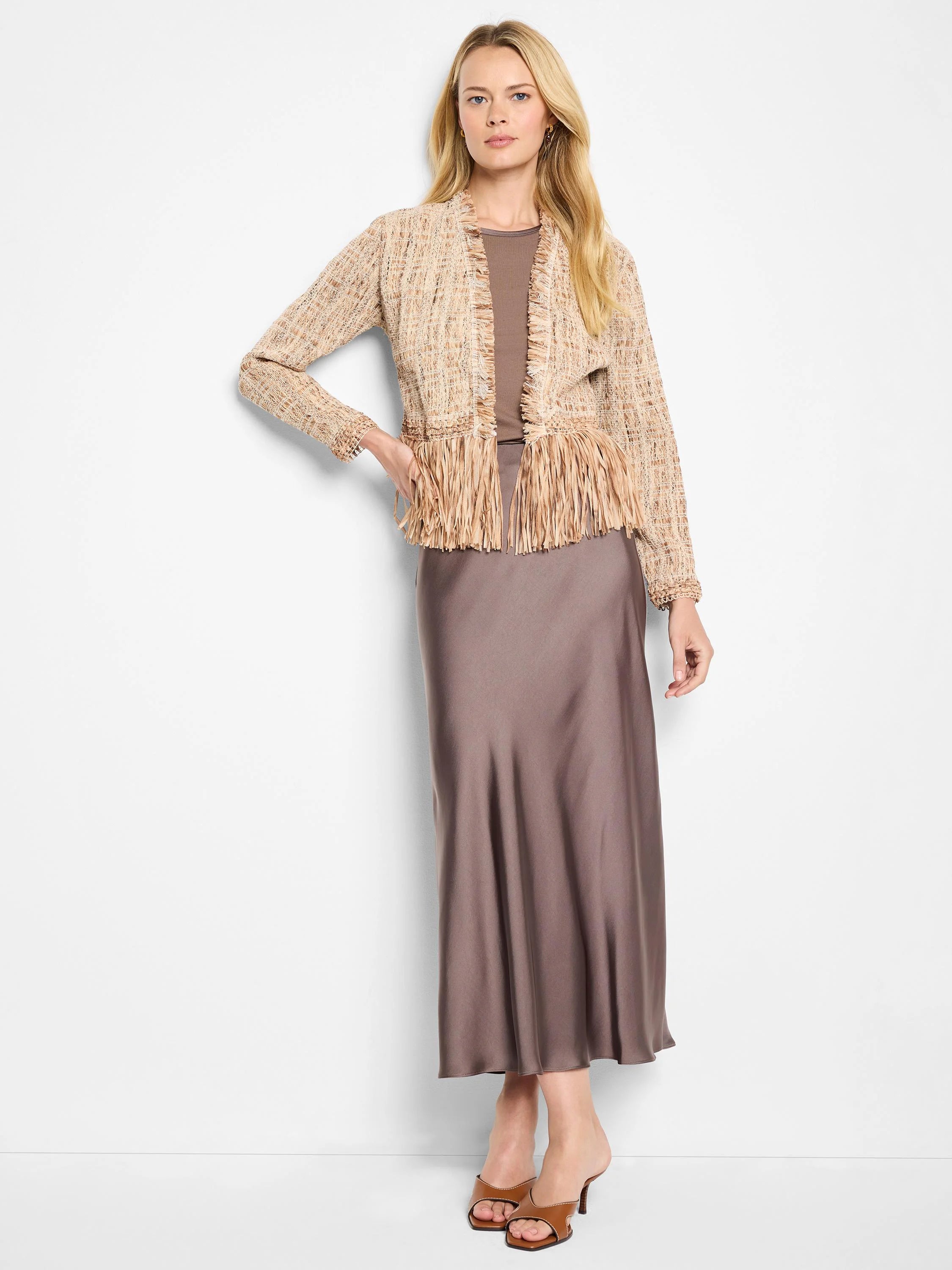 Beige knit jacket with brown fringe, shown on a model.