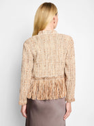 Beige knit jacket with a textured weave and long fringe at the hem.  The fringe is a similar beige/brown shade.