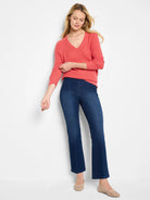 Coral V-neck waffle-knit sweater with 3/4 cuffed sleeves, worn by a model.