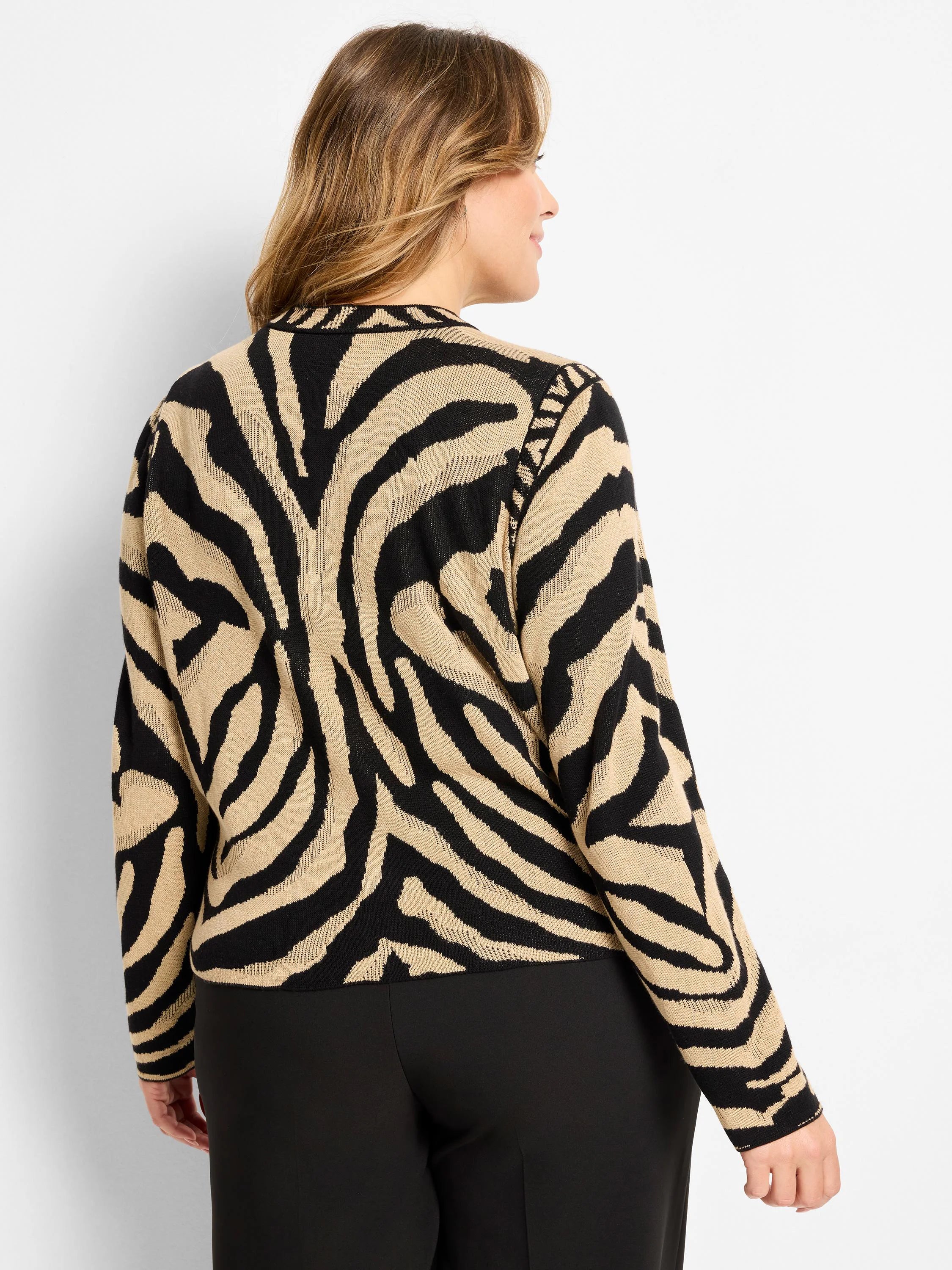 Beige and black jacquard cardigan with distinct zebra stripes.