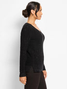 Black V-neck sweater with waffle knit texture and scattered shimmer accents.