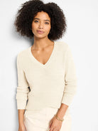Cream waffle knit V-neck sweater with subtle shimmer.