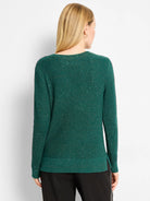 Emerald green waffle knit sweater, back view. Shimmers with metallic flecks. Has a rounded neckline and ribbed hem with...