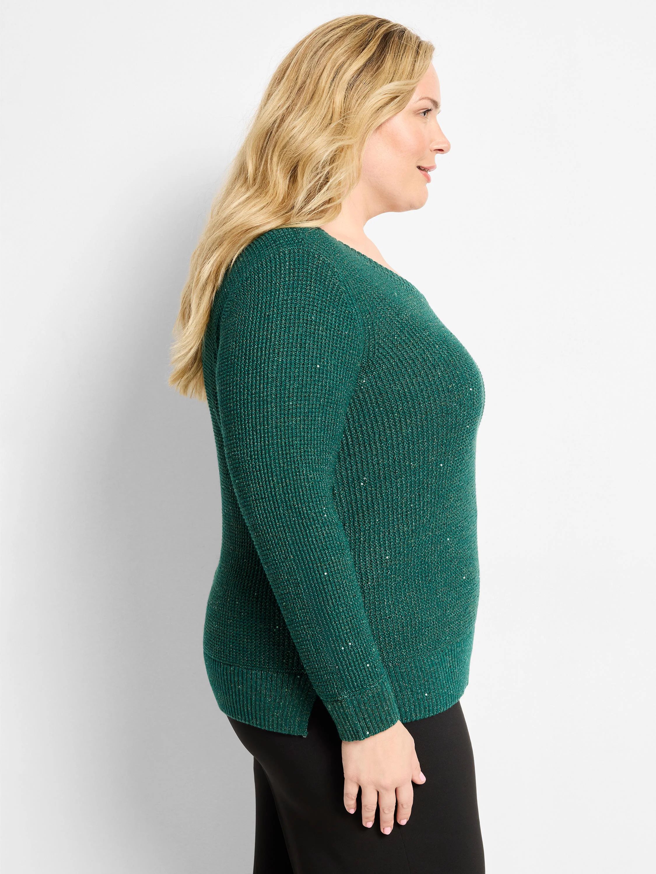 Shimmering green V-neck sweater with waffle knit texture and long sleeves, modeled from the side.