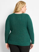 Dark green waffle knit sweater with shimmering threads. Features a relaxed fit and ribbed cuffs/hem.