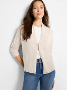Light oatmeal open-front cardigan with a soft shawl collar and long sleeves with ribbed cuffs.