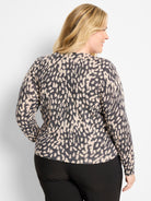 Light beige pullover sweater with scattered dark gray irregular dots. Long-sleeved.