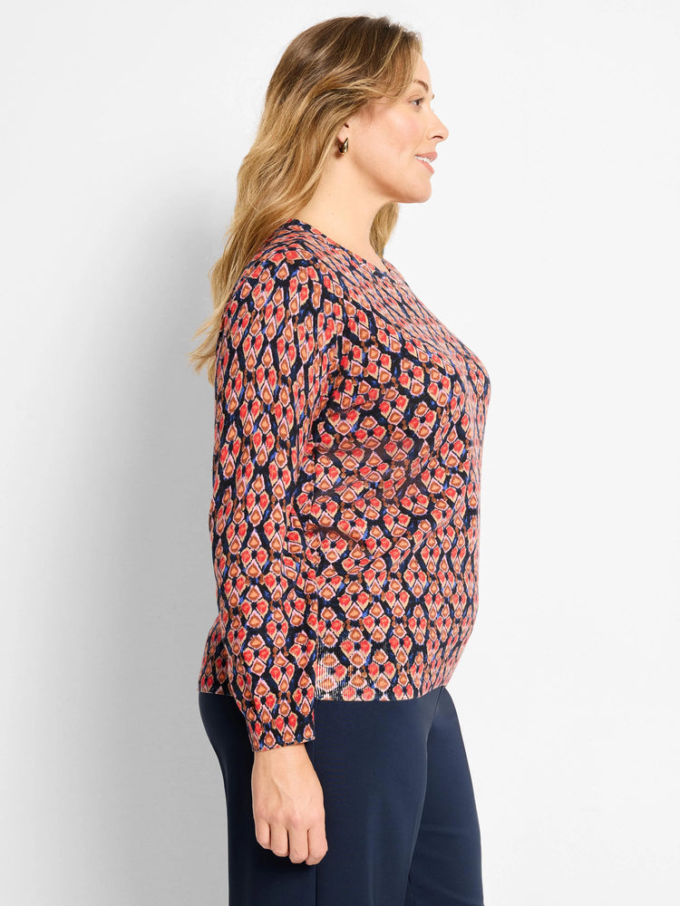Dark navy sweater with red, orange, and blue ikat diamond pattern. Round neck, long sleeves.