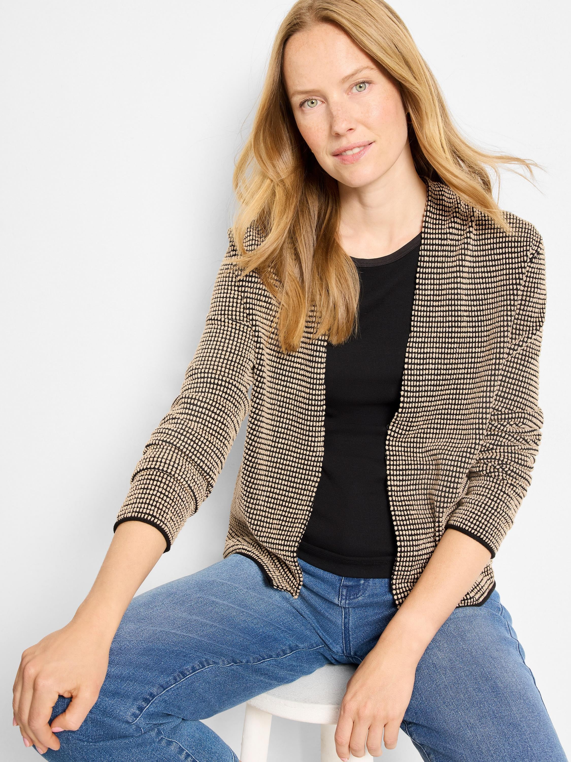 Black cardigan with beige raised pixel pattern, open front, and black trim on edges and cuffs.