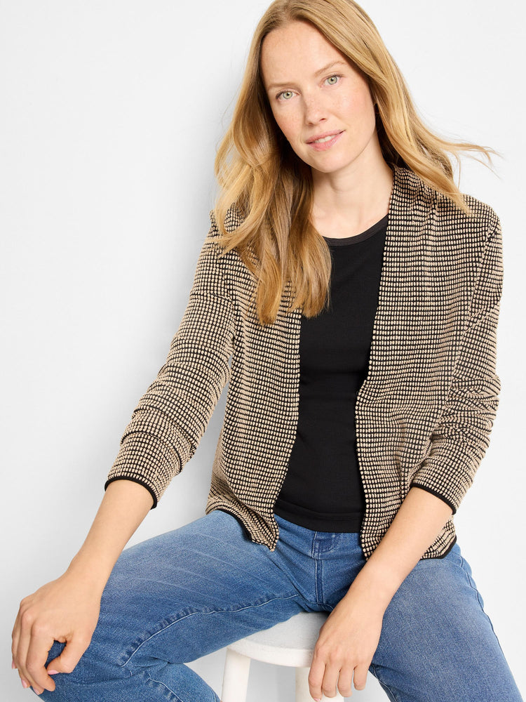 Black cardigan with beige raised pixel pattern, open front, and black trim on edges and cuffs.