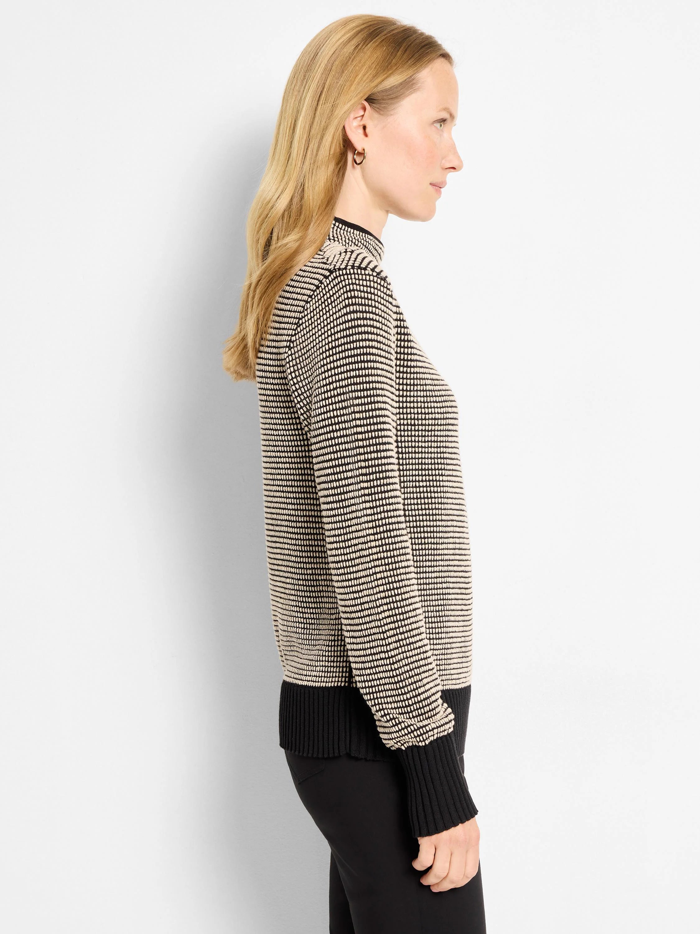 Black & tan pixel knit funnel neck sweater with ribbed black cuffs and hem.