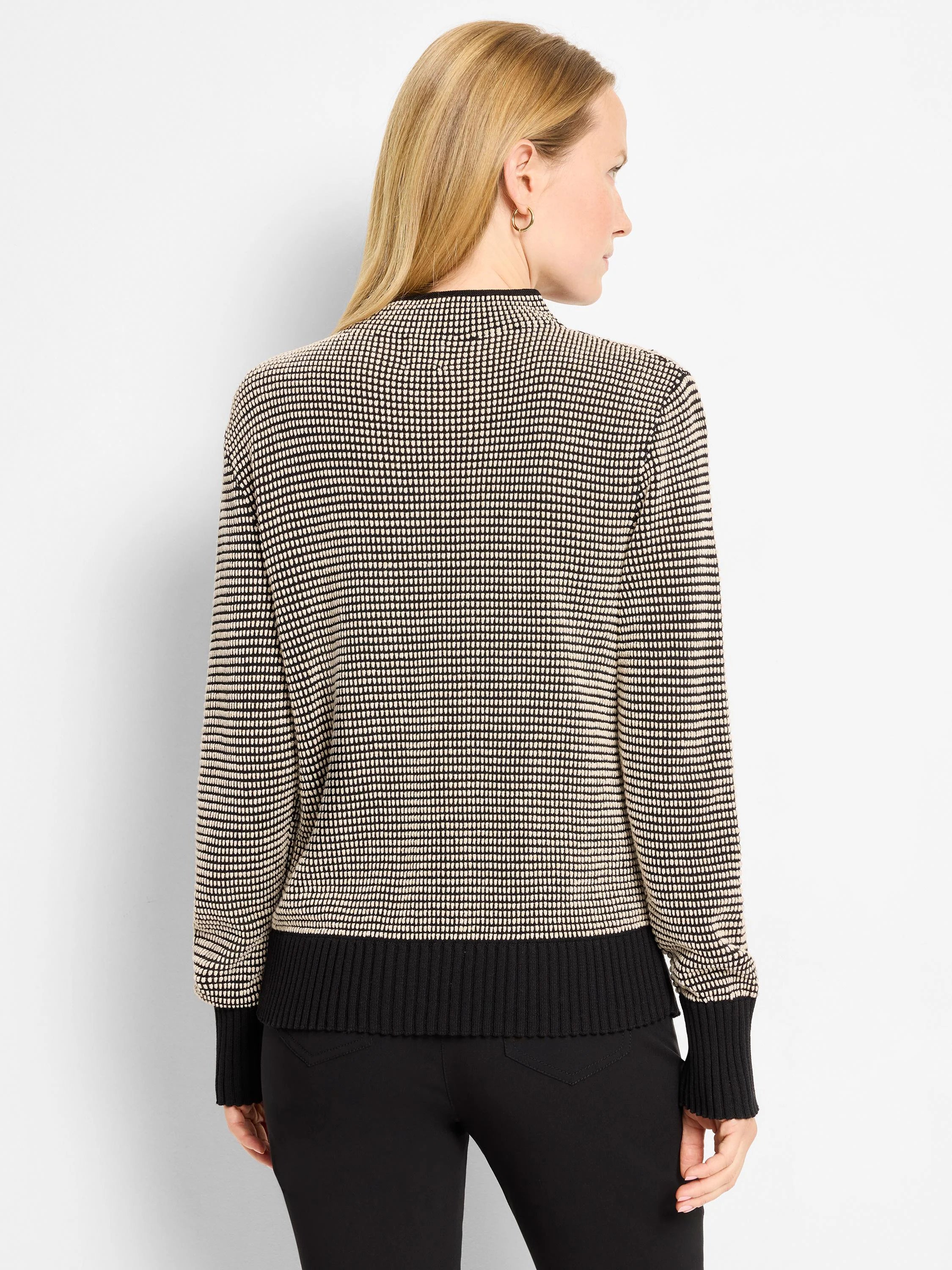 Cream and black pixel knit funnel neck sweater with ribbed black cuffs and hem.
