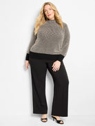 Funnel neck sweater with black & beige pixel knit pattern, solid black ribbed cuffs and hem.