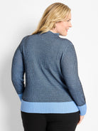 Blue & black pixel knit funnel neck sweater with light blue ribbed cuffs and hem.