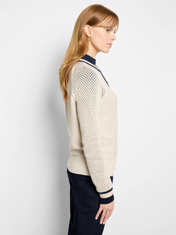 Beige cotton cardigan with navy blue trim and mesh panels.  Zipper closure.