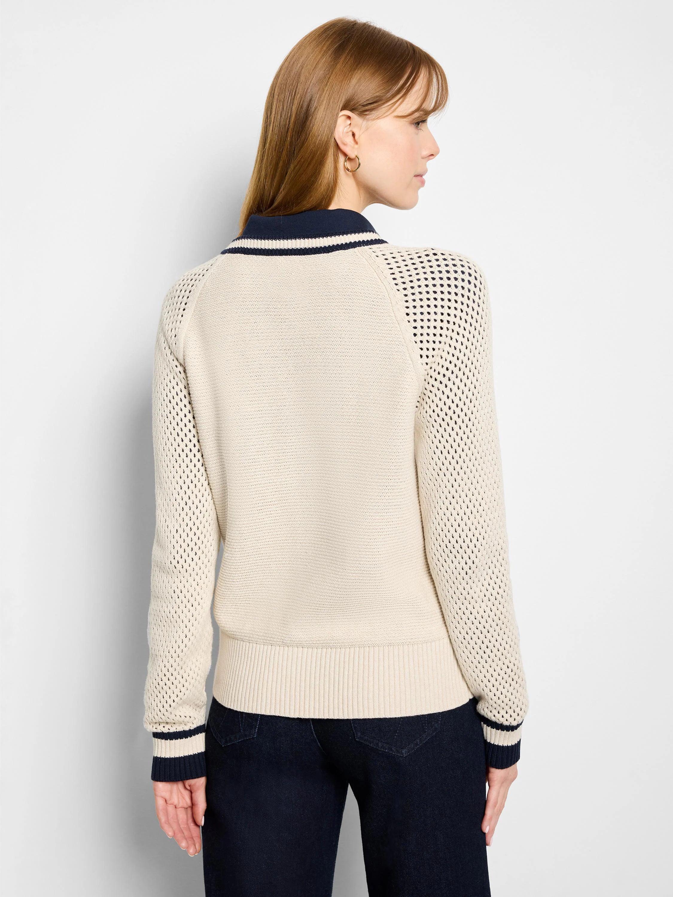Cream-colored cotton mesh cardigan, navy blue collar and cuffs.  Mesh detailing on sleeves.  Zipper closure (not visible).