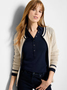 Beige cotton mesh cardigan with navy blue trim and zipper.  Mesh pattern on sleeves and back.