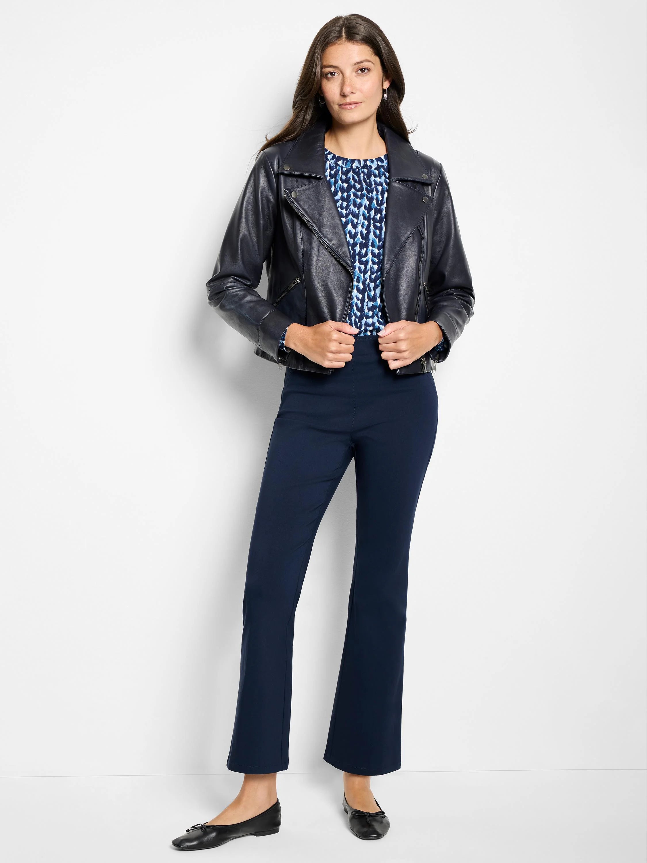 Blue knit sweater with round neck and abstract dark and light blue pattern.