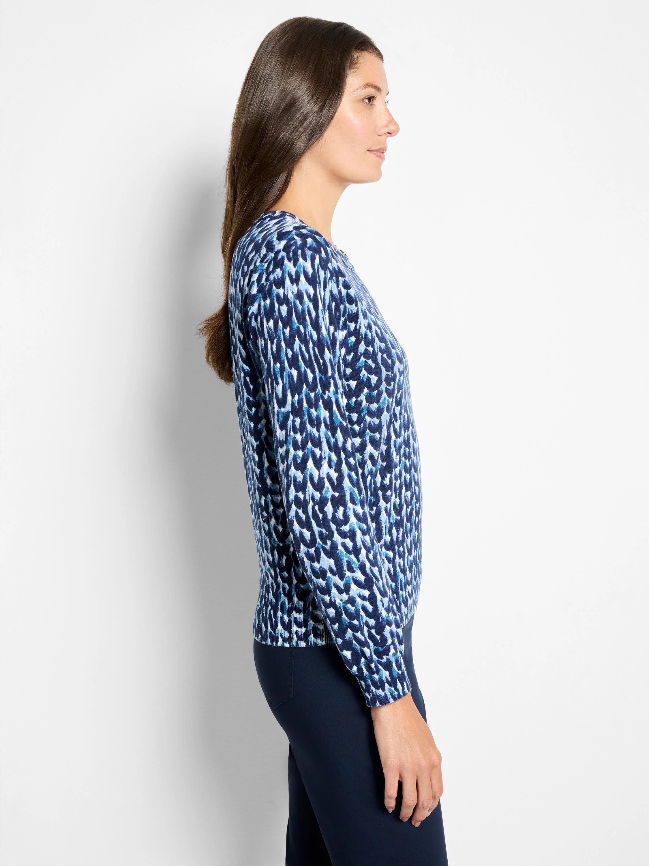 Long-sleeve sweater in shades of blue & white, featuring an abstract, irregular knit-stitch pattern.