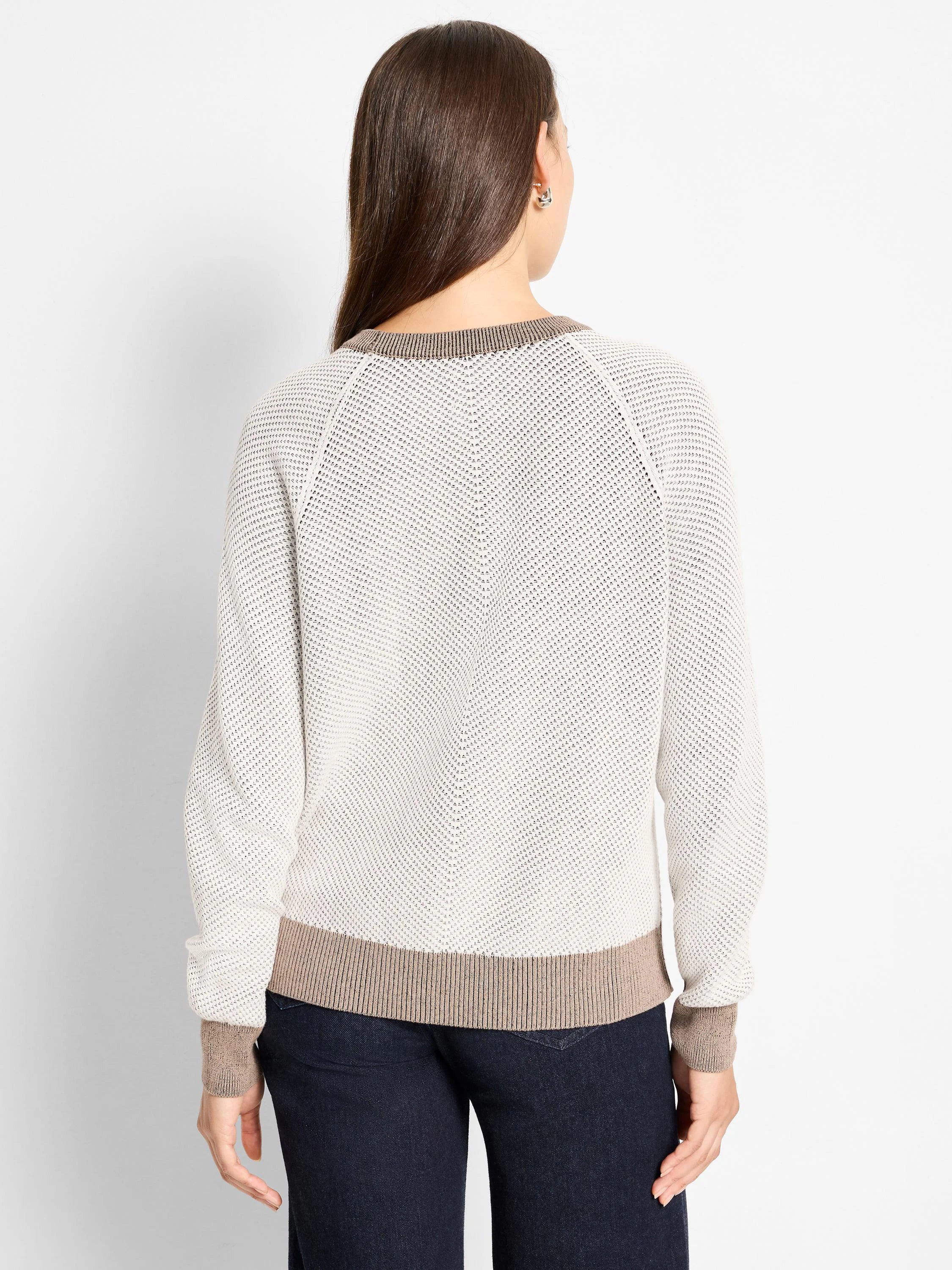 Textured cream sweater with open knit body and brown ribbed collar, cuffs, and hem. Back view.