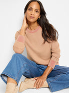 Light beige textured cotton sweater with coral-pink ribbed collar & cuffs.