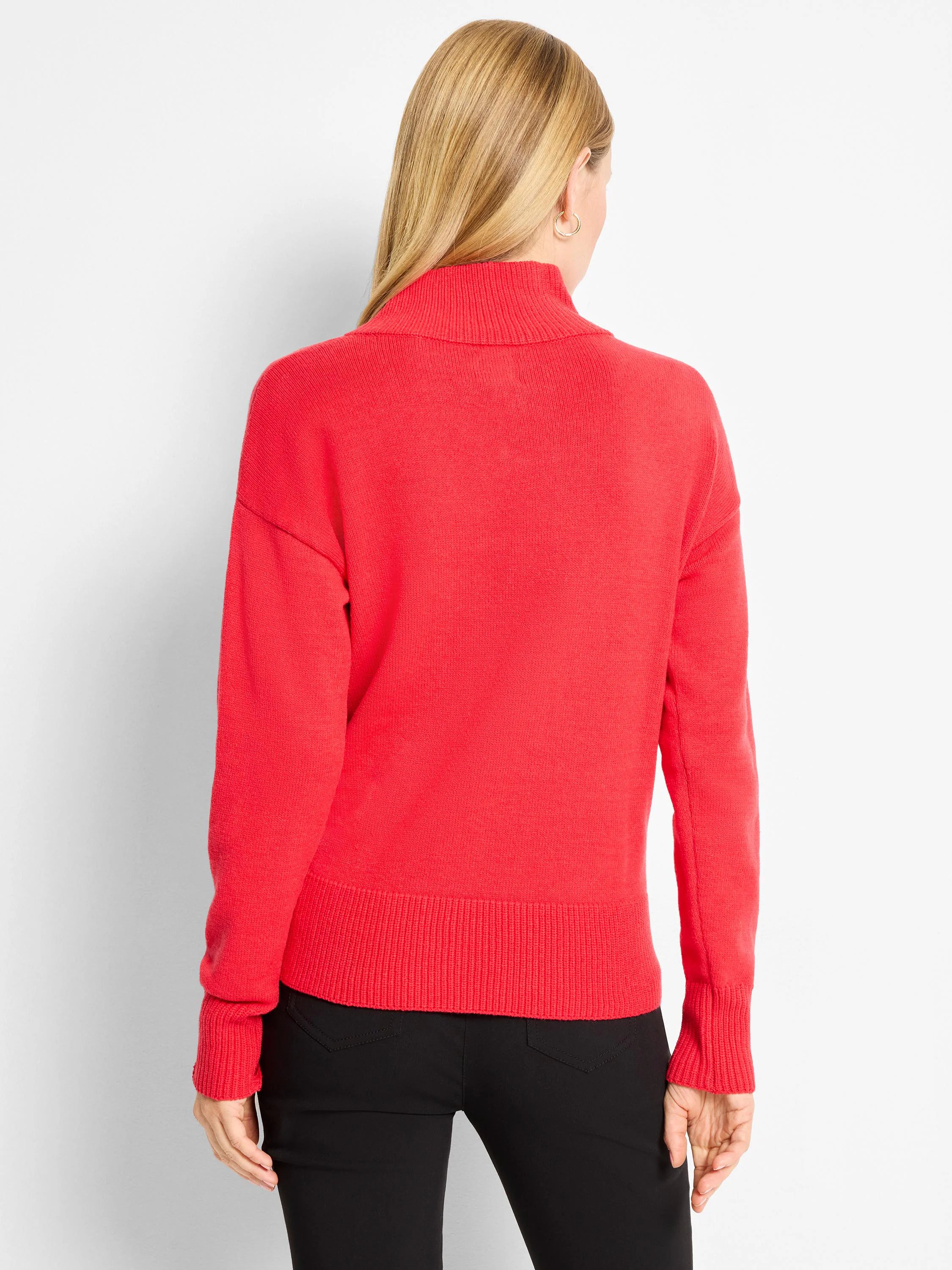 Bright red knit turtleneck sweater with long sleeves, ribbed cuffs, and hem, shown from behind on a person.