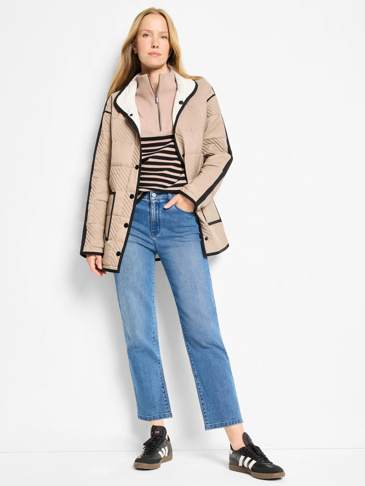 Beige quilted jacket with chevron pattern and black trim. White collar lining shows reversibility.