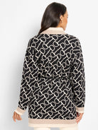 Black & cream horse bit pattern jacket with thin black belt, beige collar, cuff, & hem trim.