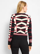 Black, off-white, and red geometric cardigan with zig-zag stripes and intersecting red lines.
