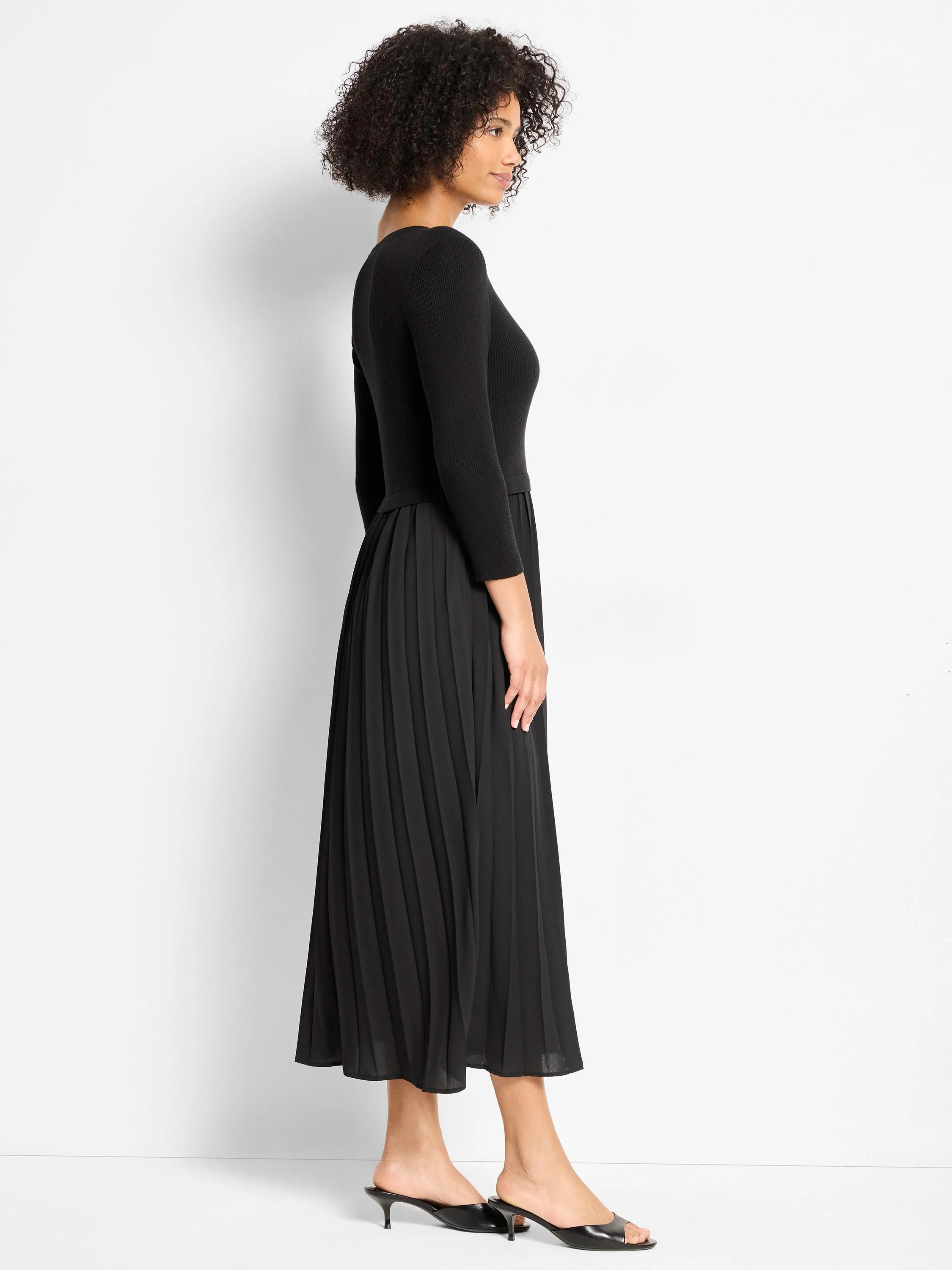 Black dress with a ribbed knit bodice and a pleated midi skirt.