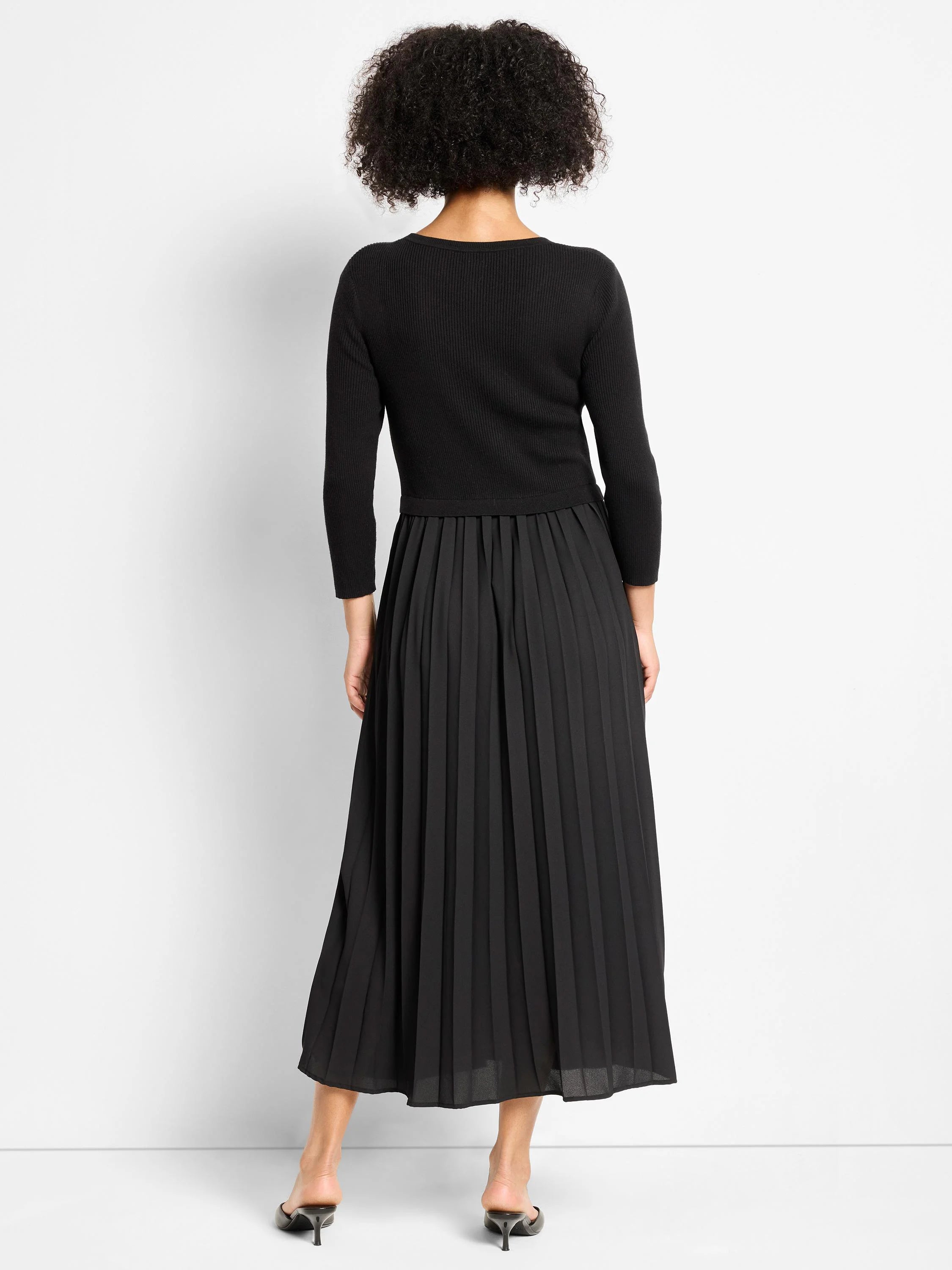 Black Kyrie dress with a ribbed long-sleeve top and a full, pleated maxi skirt.