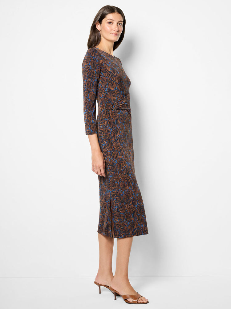 Woman wearing a patterned dress on a white background