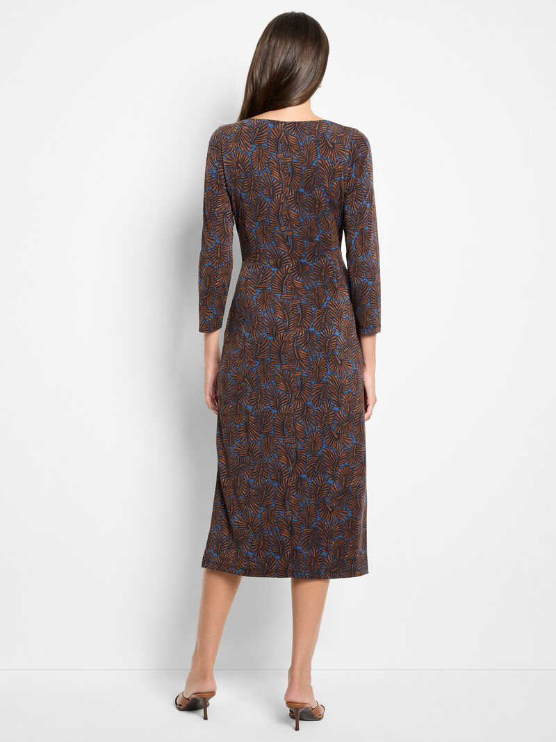 Woman wearing a patterned dress on a white background