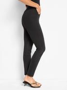 Black fitted pants with a high waist, flat side pocket, and quilted knee patches.