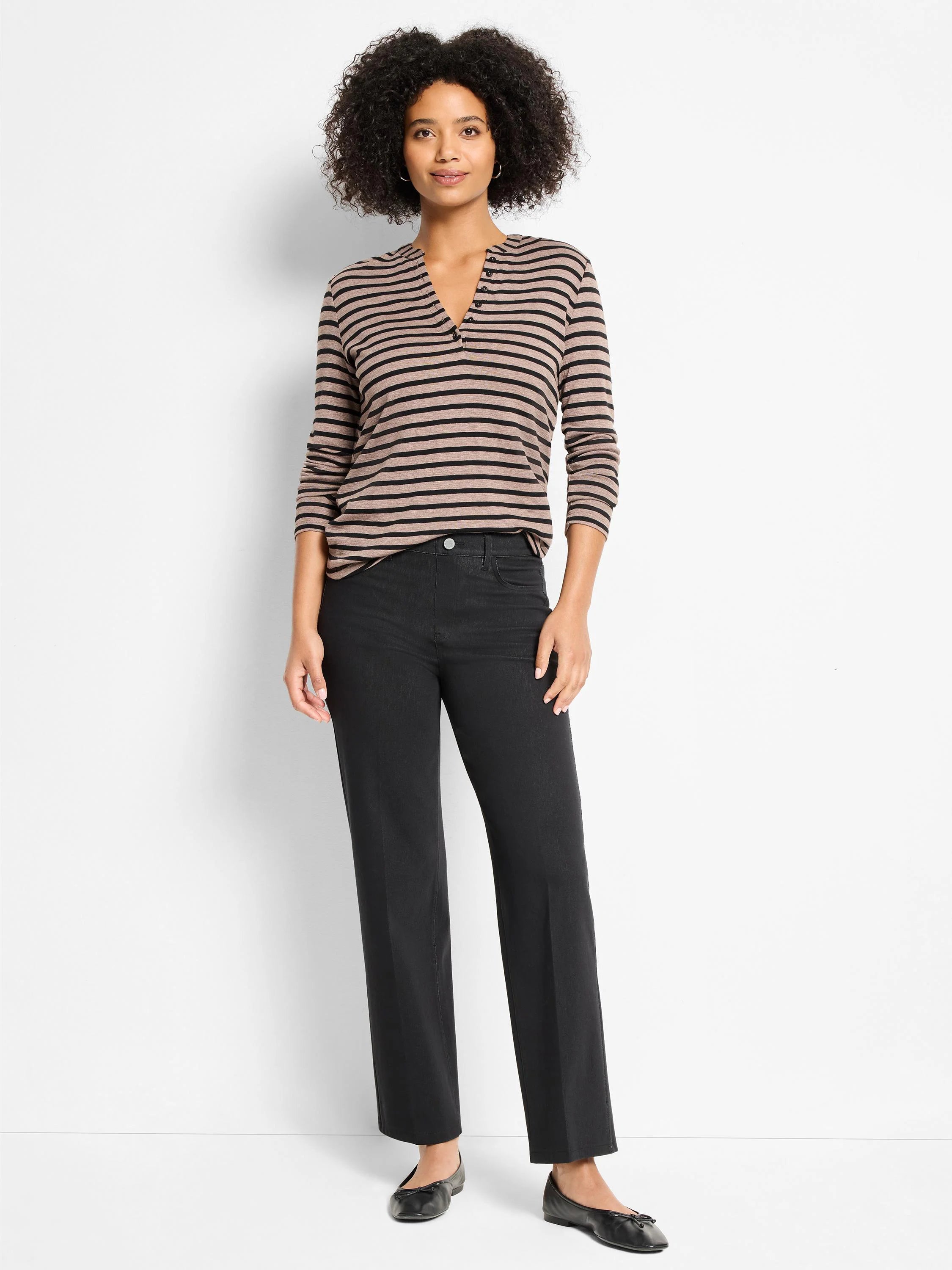 Black straight ankle jeans on a model, featuring a flat waistband and straight leg.