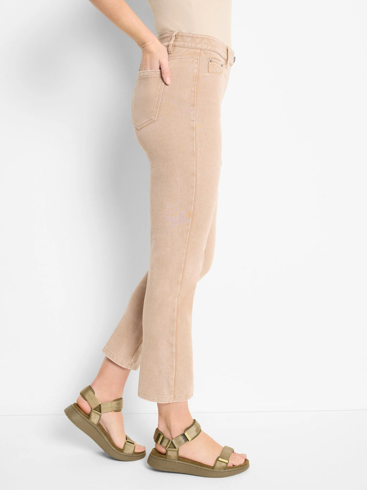 Beige straight knit ankle jeans worn by a model, showing front pockets, belt loops, and button closure.