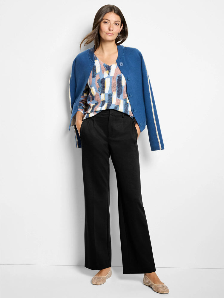 Black wide leg trousers on model, showing a smooth drape, front creases, and pockets.