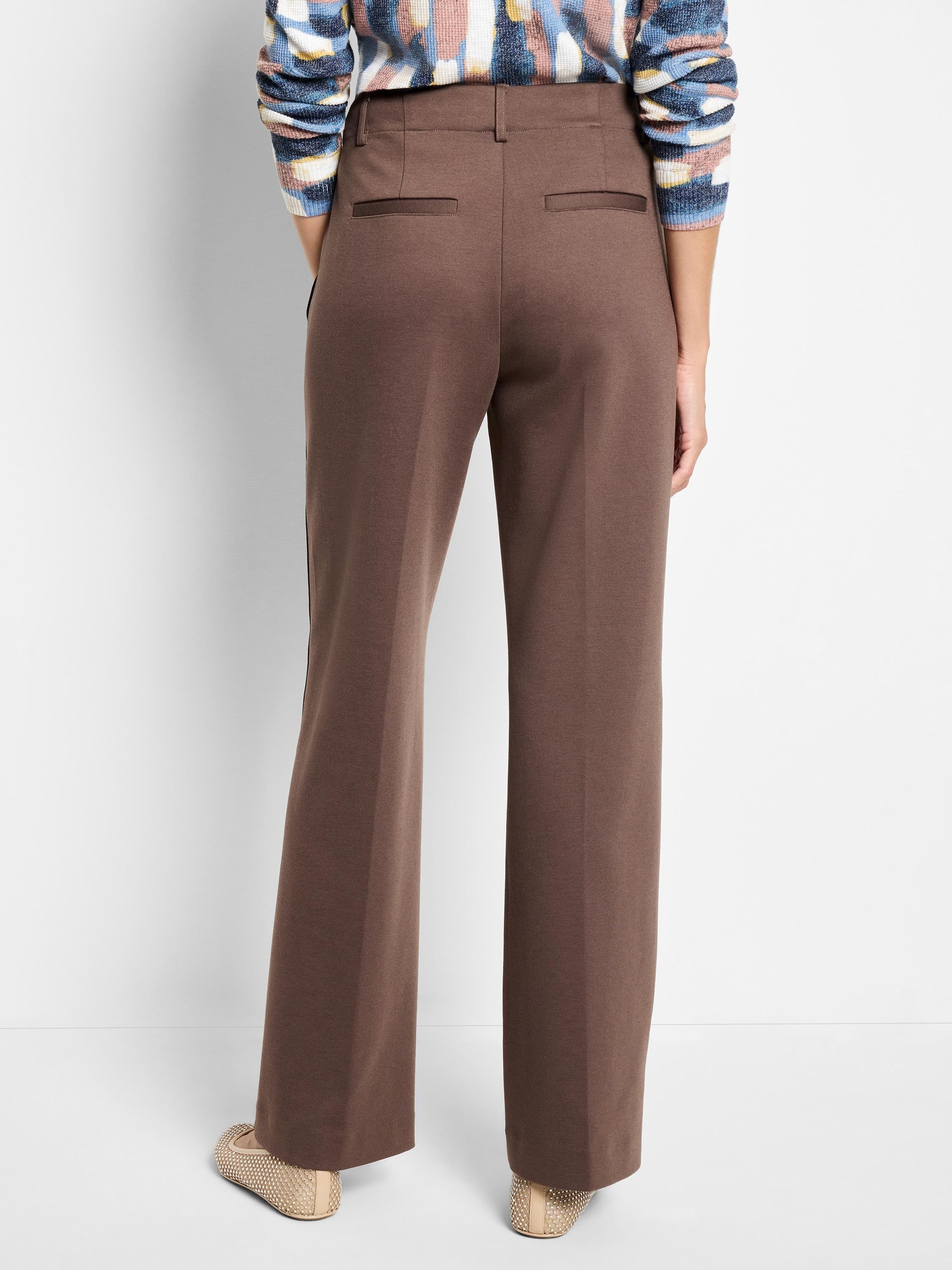 Dark brown wide-leg trousers with a drapey look, featuring back welt pockets and belt loops.